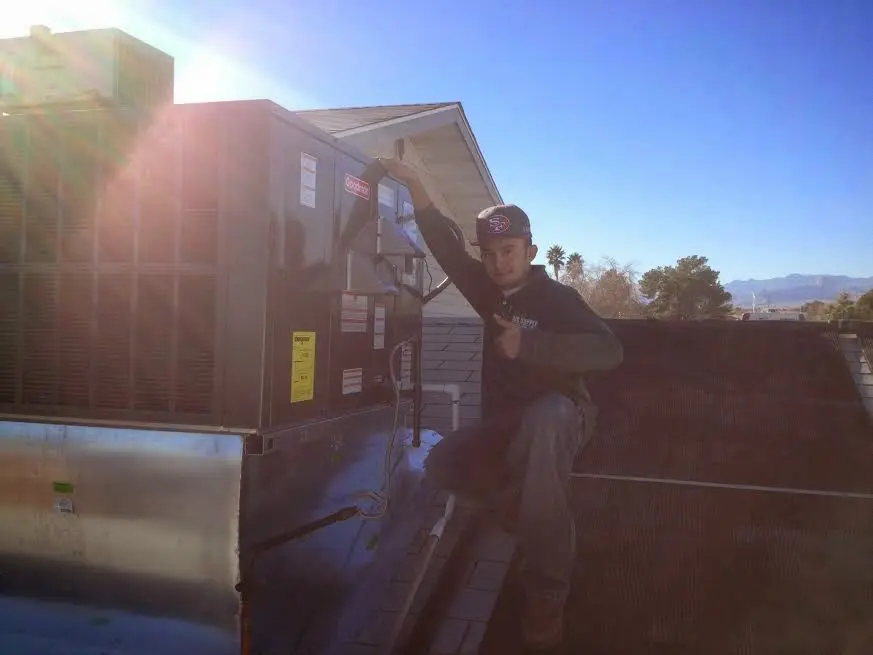 HVAC technician performing HVAC Inspection on a rooftop unit in Douglas